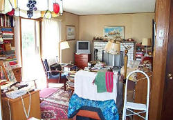 Before staging photo of a room in a residence showing the clutter and confusion of styles